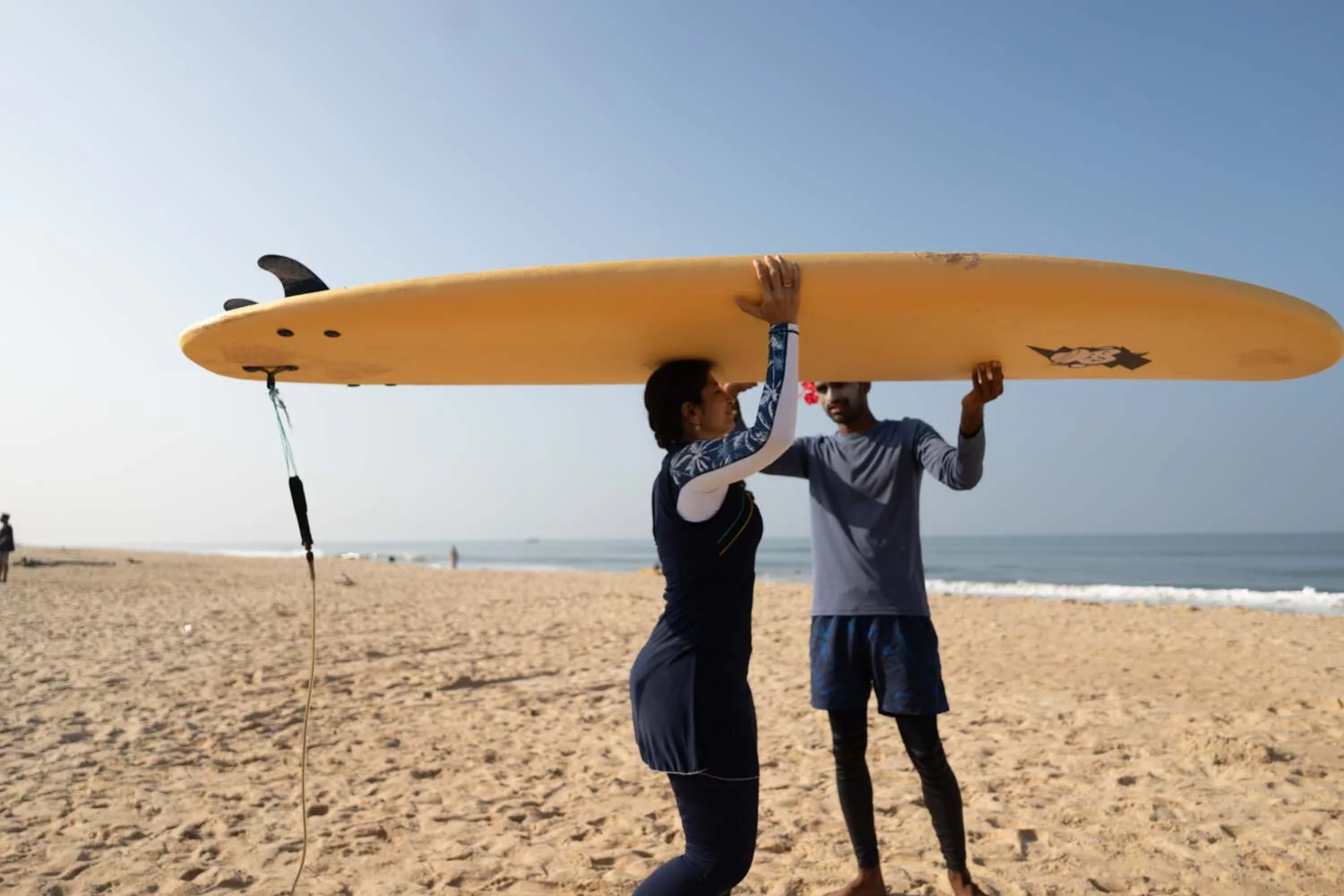 Surf-school lesson with learner boards on the beach