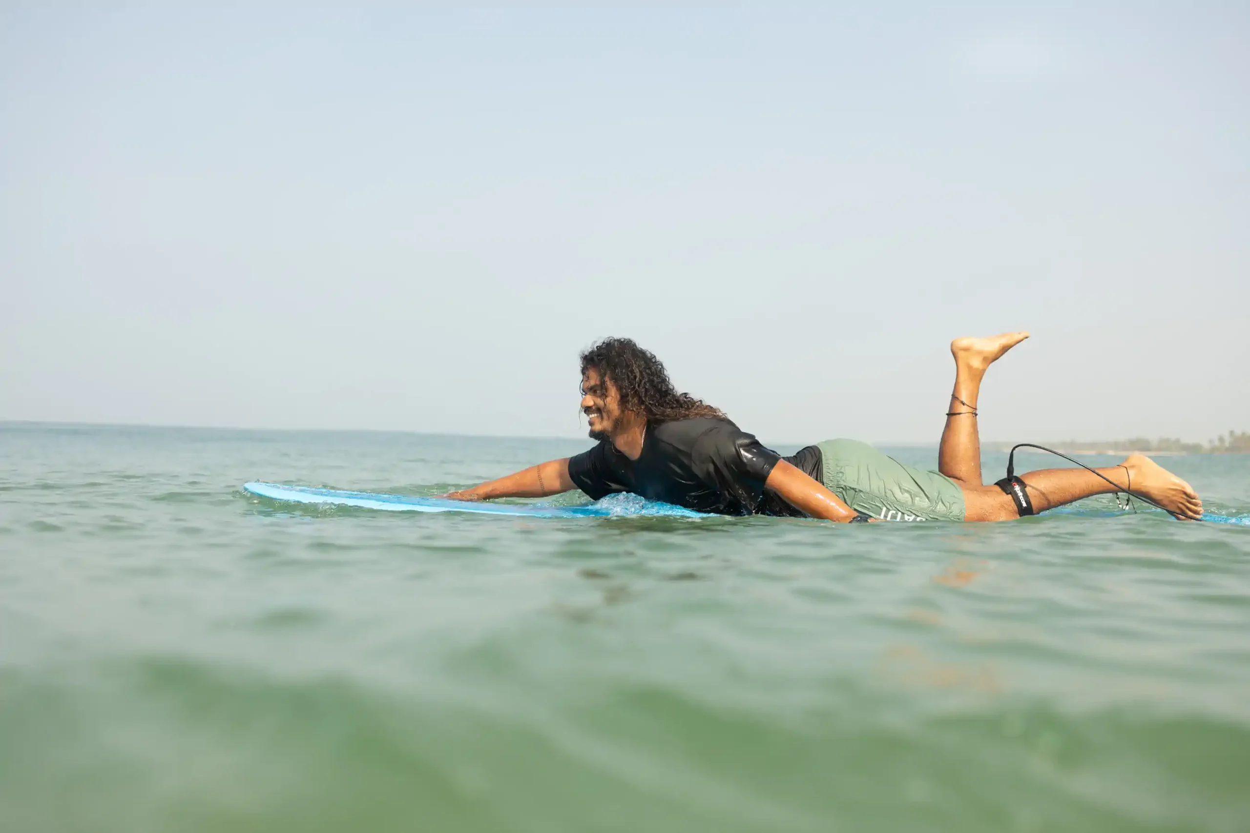 Surfer carving across a wave with spray