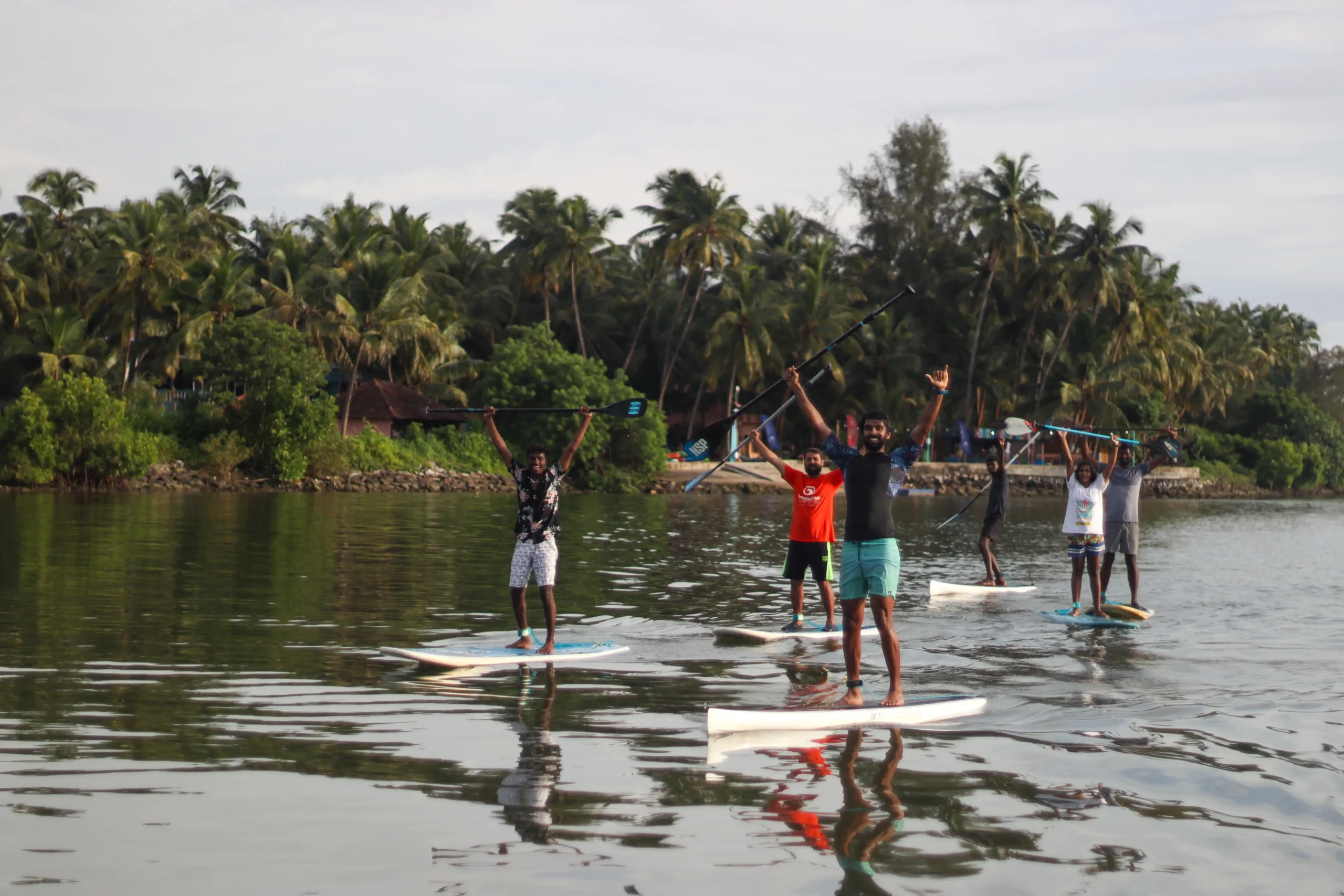 Group of people paddleboarding together on calm water