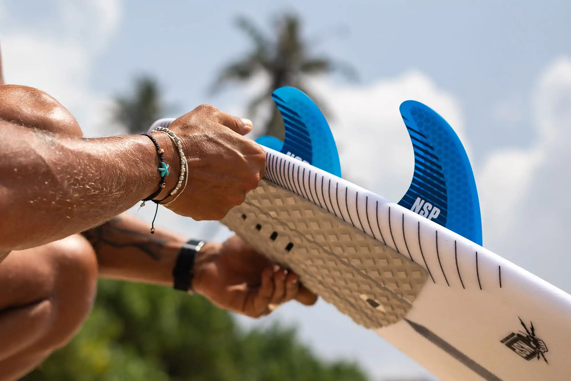 Surfer riding a small wave on a blue surfboard