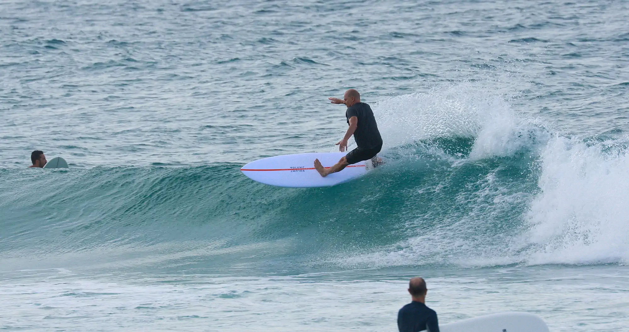 Surfer carving across a clean wave