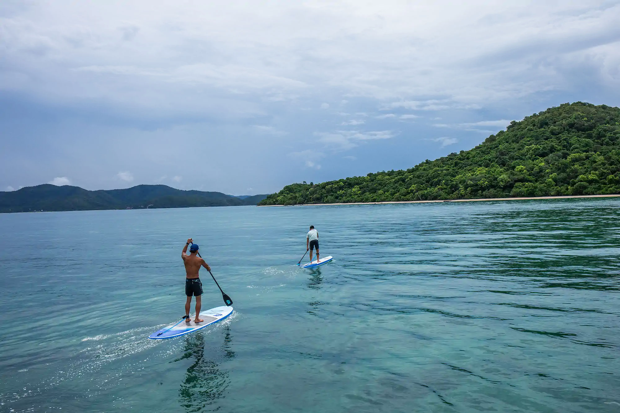 Paddleboarder moving through calm river water